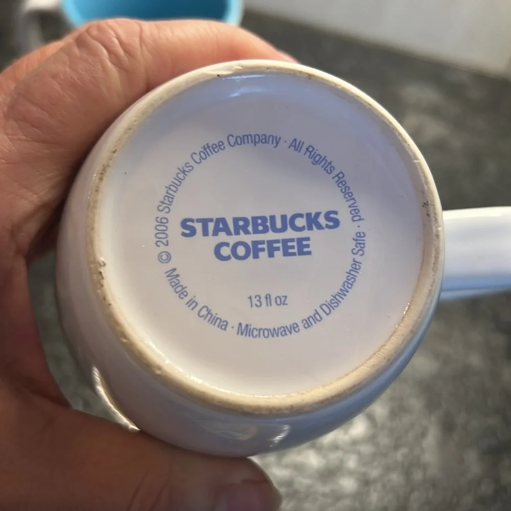 2-13oz Starbucks 2006 white and blue coffee mugs. In excellent condition.